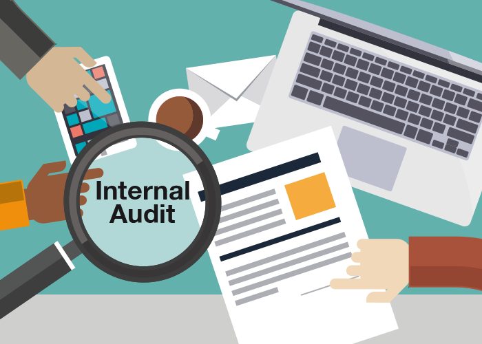 Internal Audit | Sukh Sandhu An internal audit is being conducted with documents, a laptop and magnifying glass to ensure compliance.