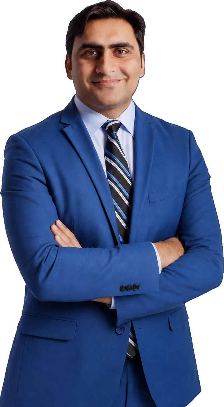 Sukh Sandhu | sukh-sandhu A man in a blue suit and tie poses with arms crossed, representing Sukh Sandhu's role as a UN Representative.